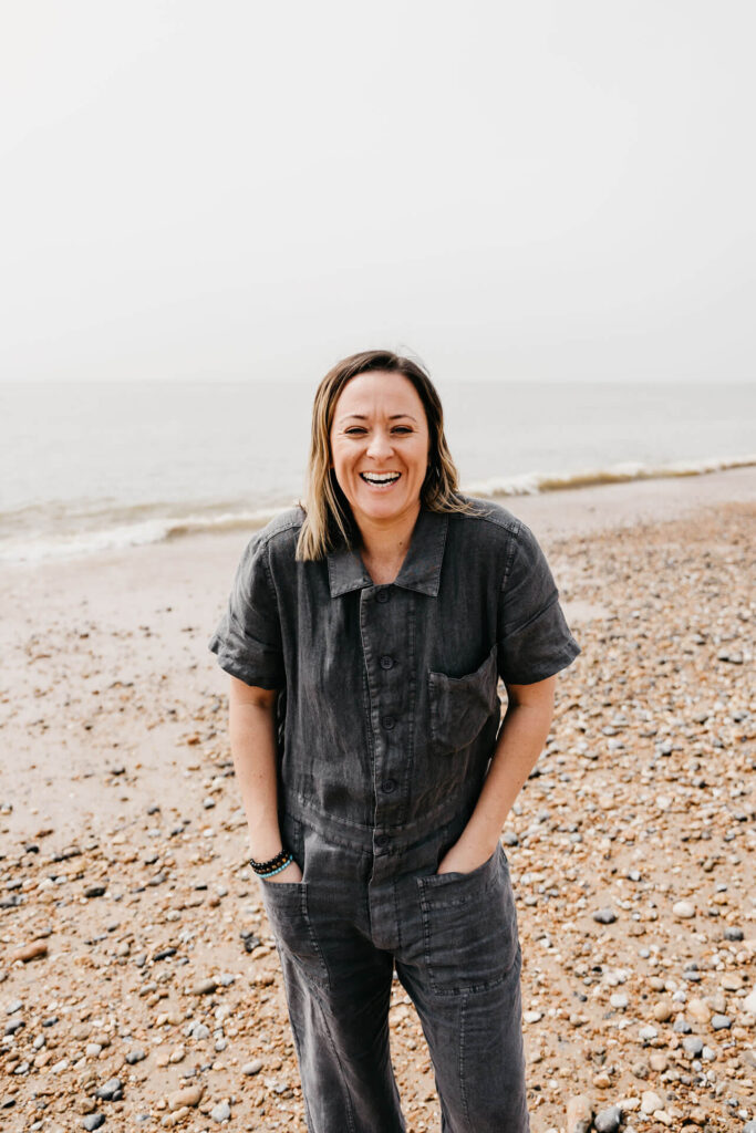 Kiera Chapman. Laughing on sea shore.