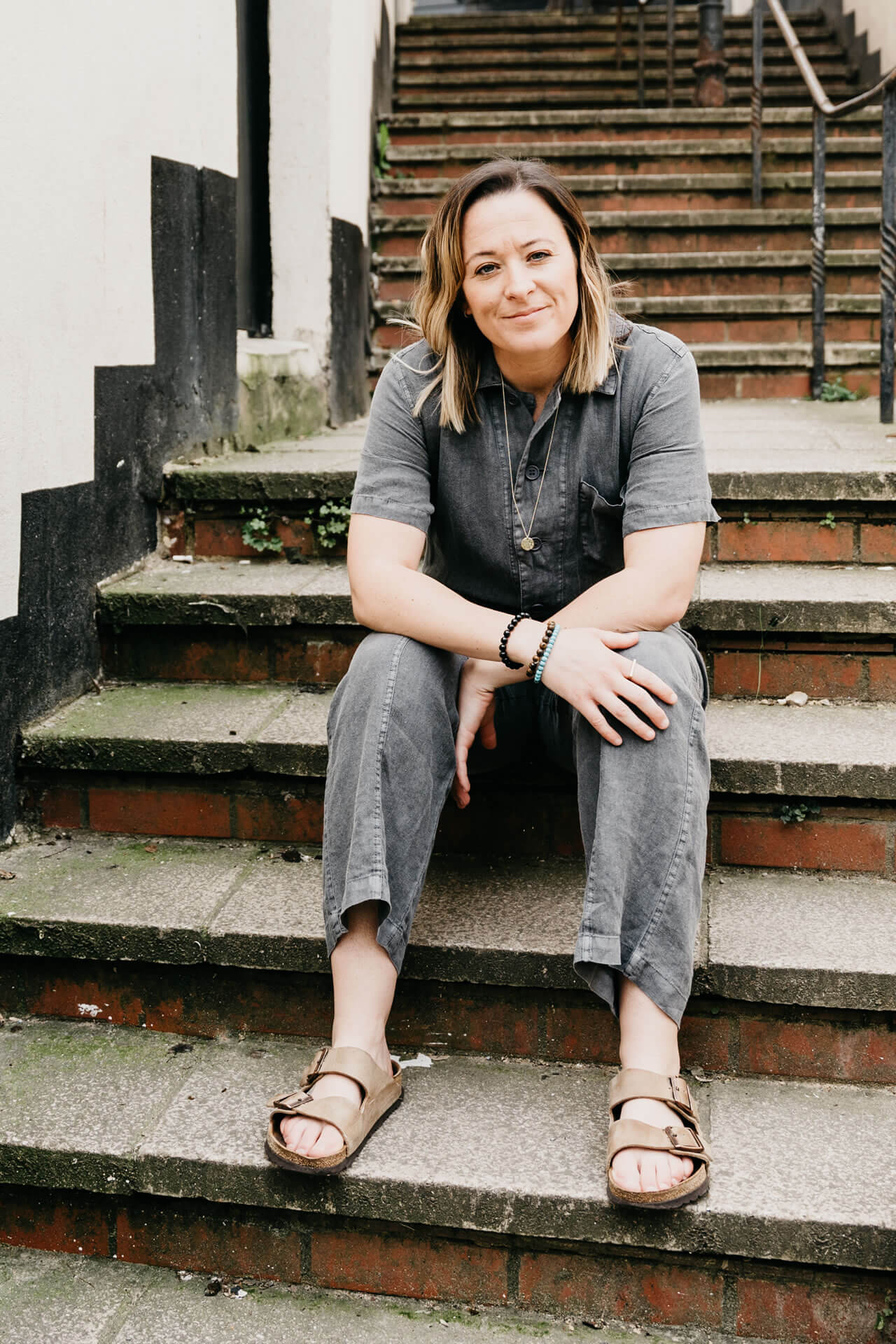 Kiera Chapman. Sitting on steps.